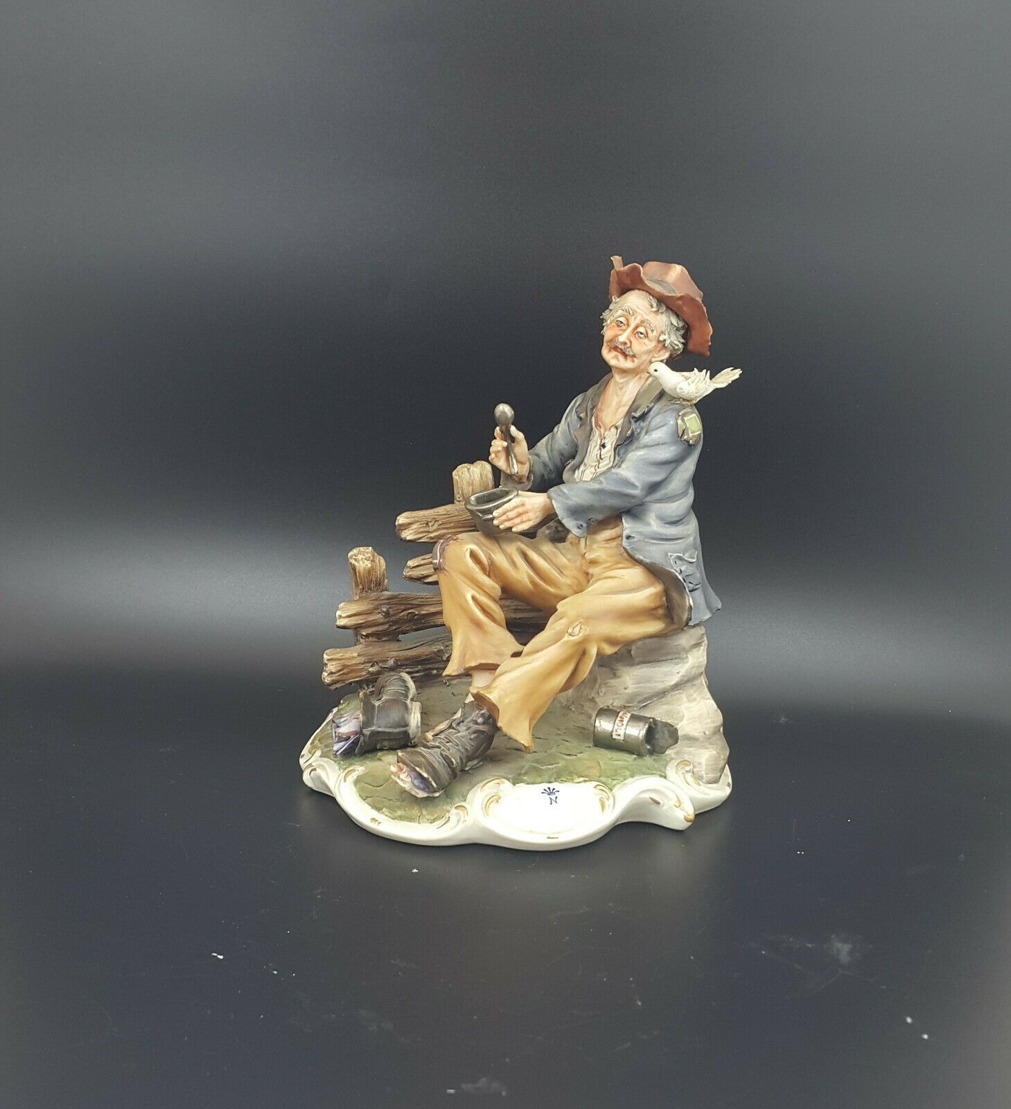 Capodimonte Figurine Large Tramp On Bench With Bird Eating – Amazing Antiques Etc.